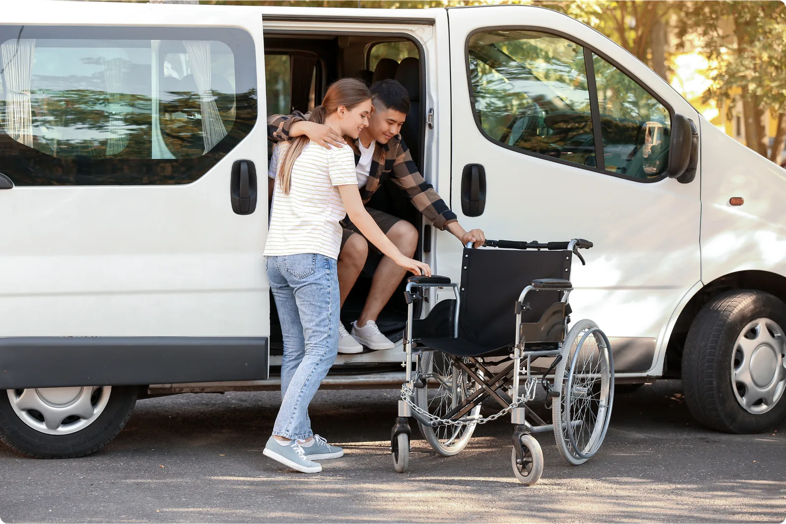 A caregiver helping an injured worker out of a van and into a wheelchair