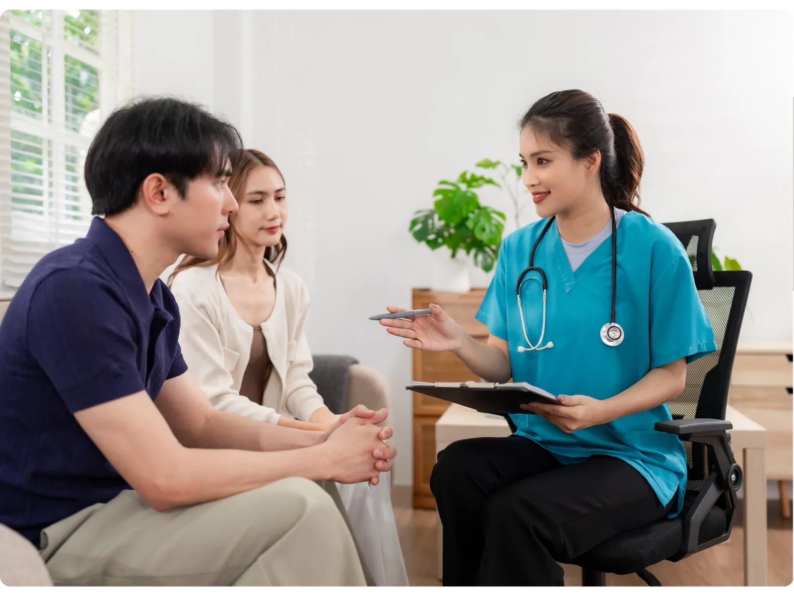 A home health nurse meeting with an injured worker and his family at home